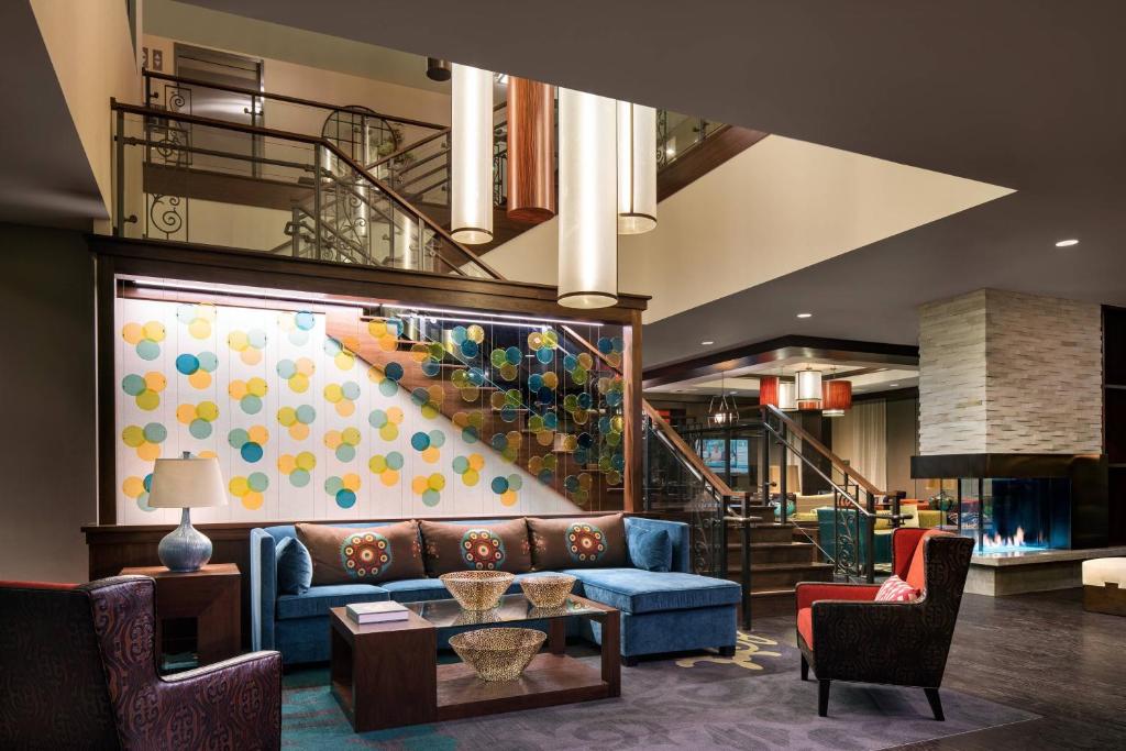 a lobby with a blue couch and a staircase at Residence Inn by Marriott Los Angeles Pasadena/Old Town in Pasadena