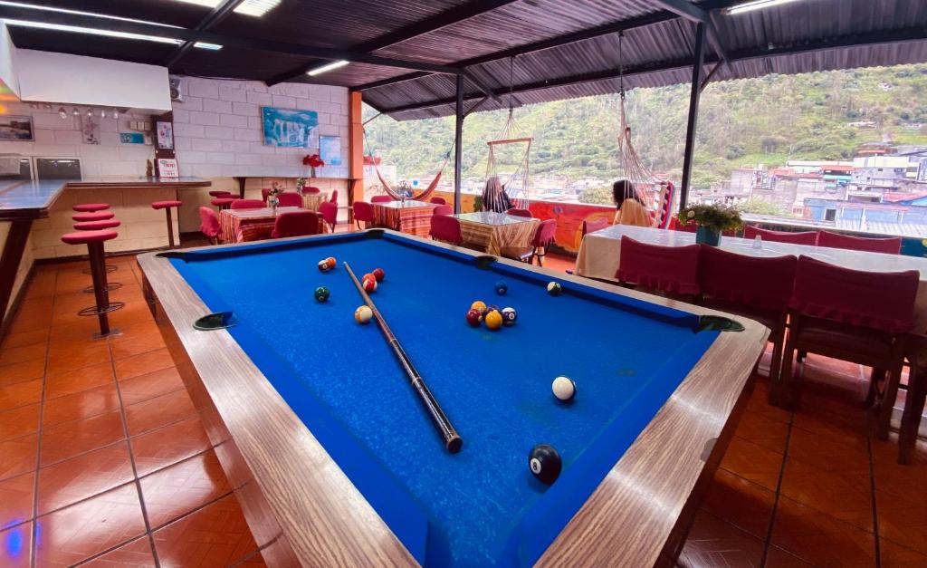 a pool table with balls on it in a restaurant at Hostal El Oro in Baños