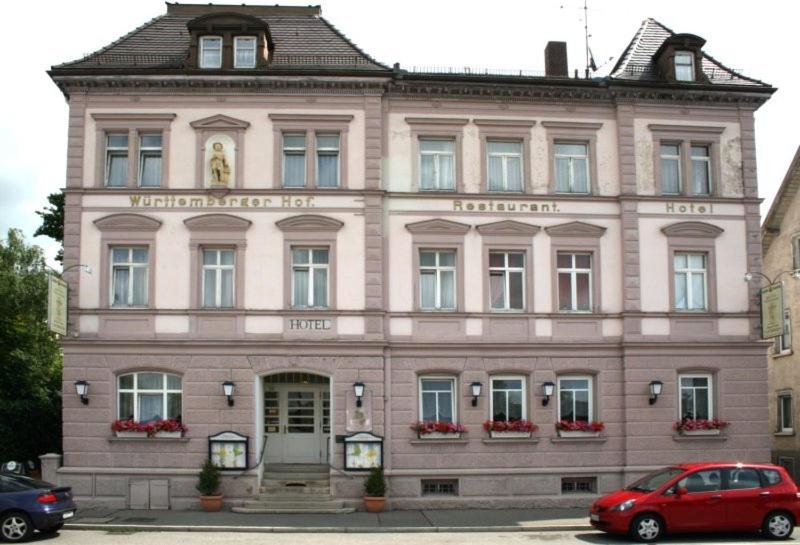 a red car parked in front of a building at Komforthotel-Restaurant Württemberger Hof in Bad Saulgau