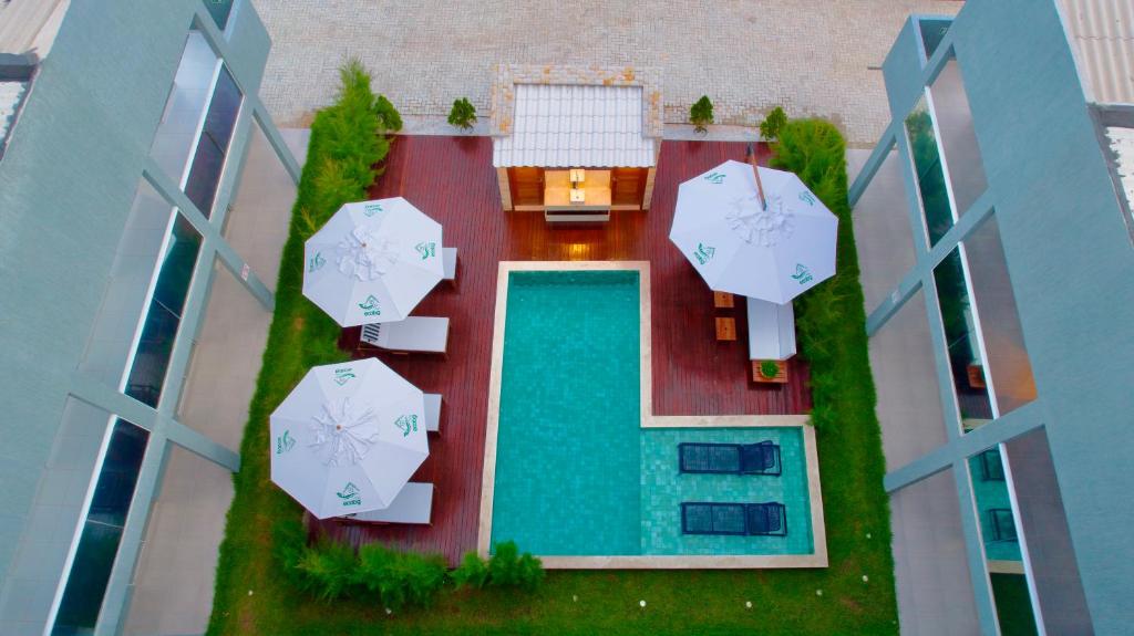 un modello di edificio con piscina e ombrelloni di Apartamento localizado em condomínio fechad0 em Barra Grande - PI a Parnaíba