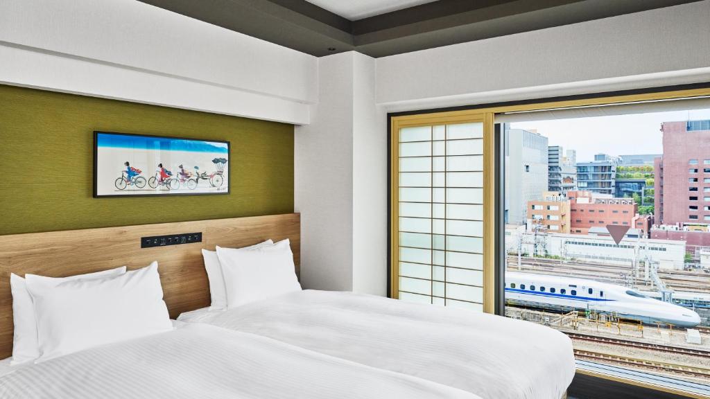 Postel nebo postele na pokoji v ubytování MIMARU Kyoto Station