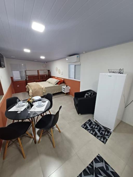 a living room with a table and chairs and a couch at Apartamento Termas do Gravatal in Gravatal