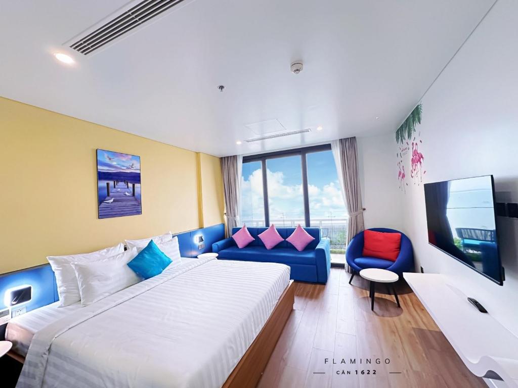 a hotel room with a bed and a couch and a tv at Flamigo Ibiza Hải Tiến Tầng 16 in Nam Khê