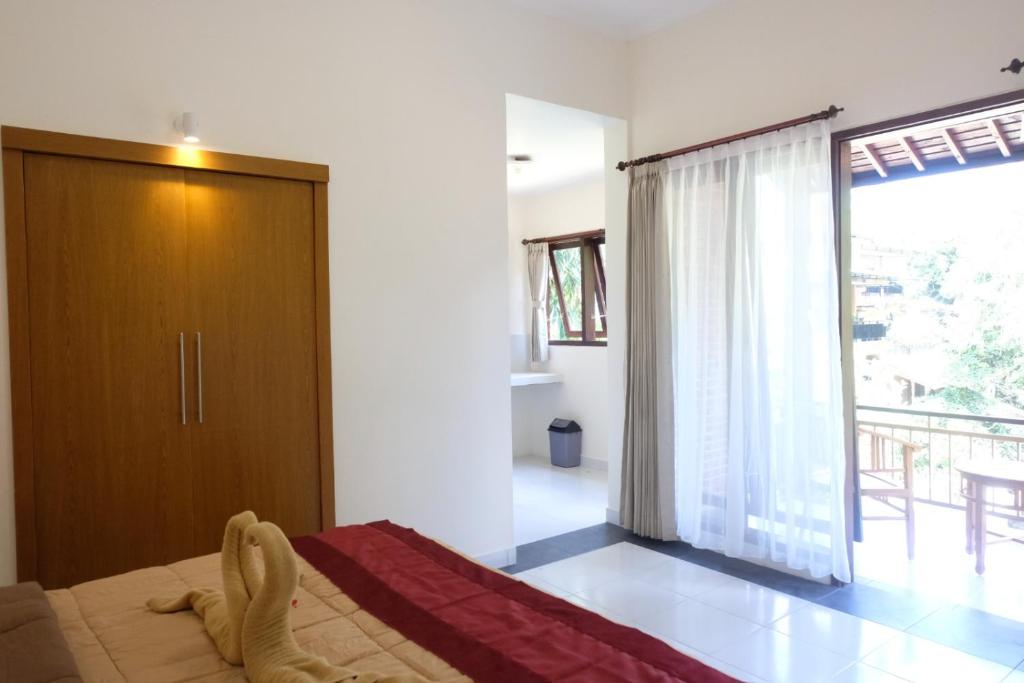 Postel nebo postele na pokoji v ubytování Ary House Ubud