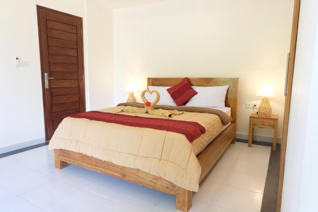 Postel nebo postele na pokoji v ubytování Ary House Ubud