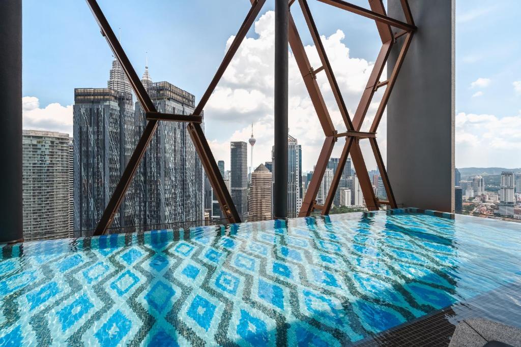 a swimming pool on the top of a building at Scarletz KLCC Apartments by soulasia in Kuala Lumpur