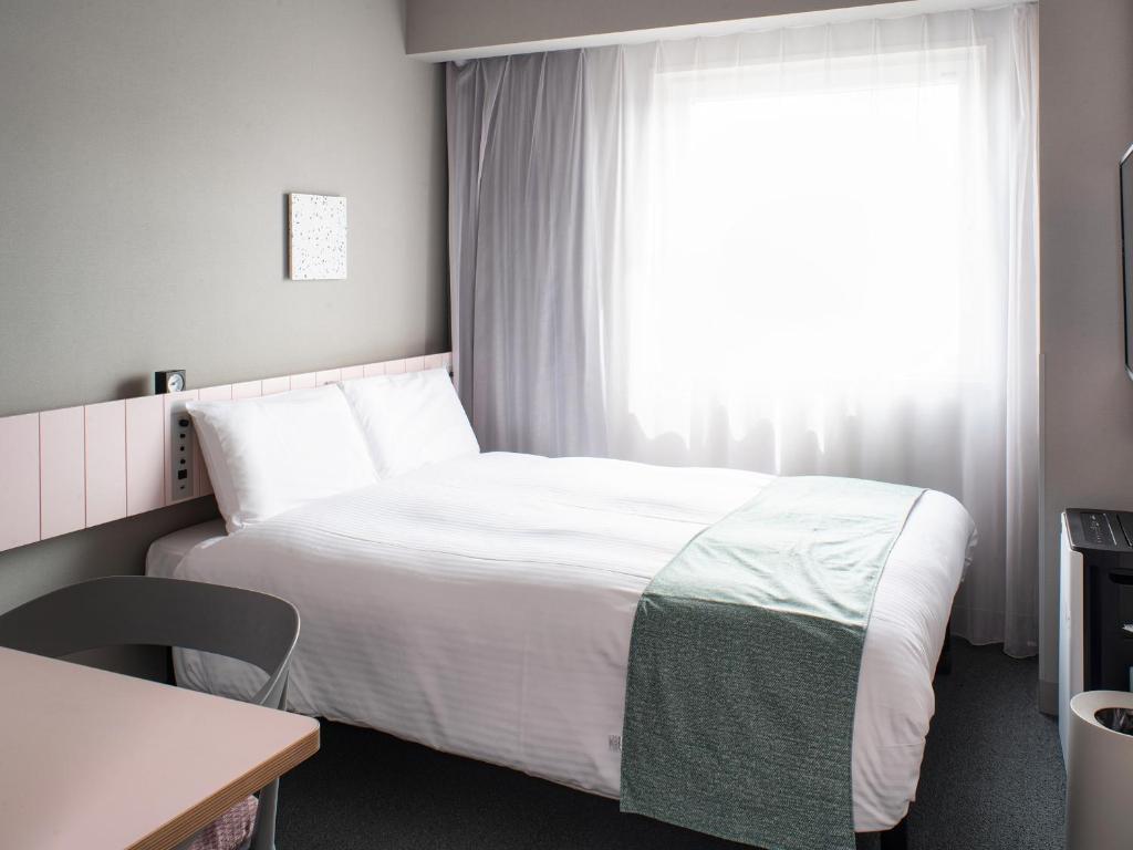 Postel nebo postele na pokoji v ubytování Vessel Inn Takadanobaba Station