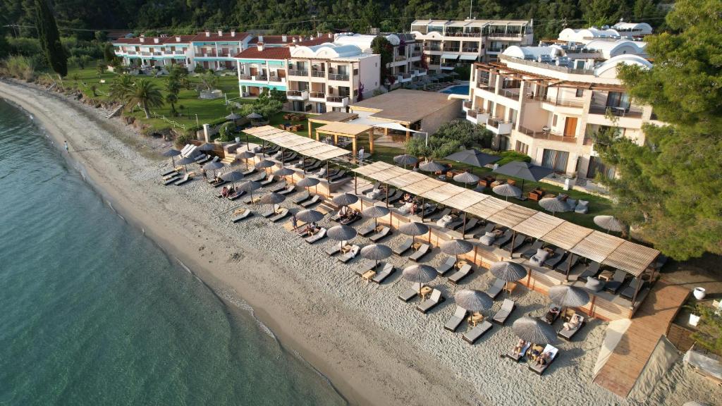 an aerial view of a beach with umbrellas at Olympion Sunset Halkidiki in Fourka