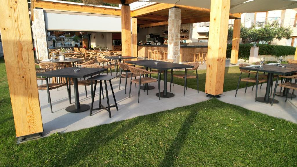 a group of tables and chairs under a pavilion at Olympion Sunset Halkidiki in Fourka