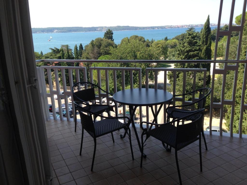 a table and chairs on a balcony with a view of the water at Apartment Jadranka in Portorož