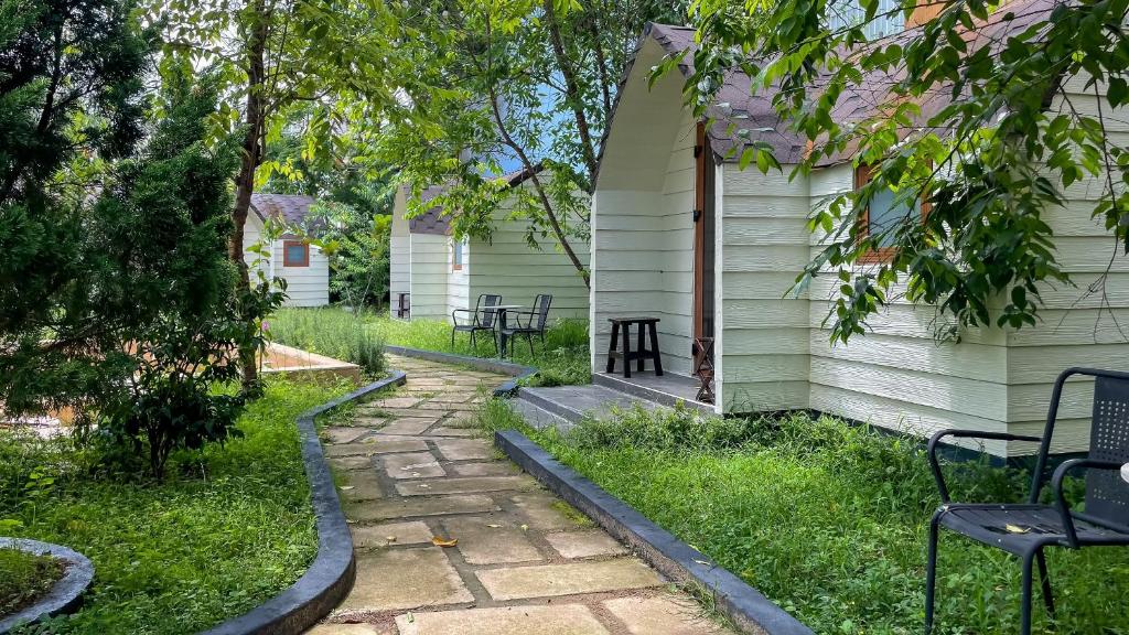 a garden with a stone walkway next to a house at Cottage Retreat DALAT in Da Lat