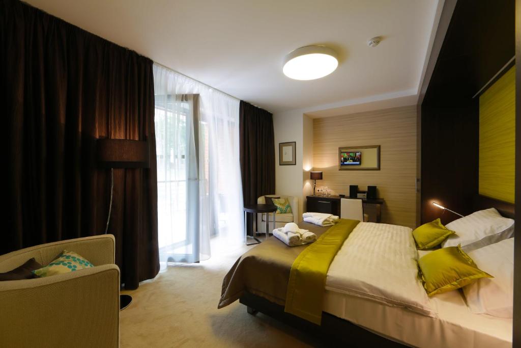 Postel nebo postele na pokoji v ubytování Hotel Zelená Lagúna