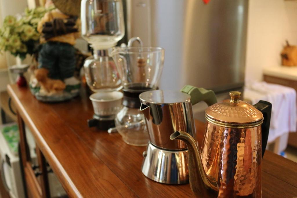 a wooden counter top with various glass items on it at Zhileju Homestay in Hualien City