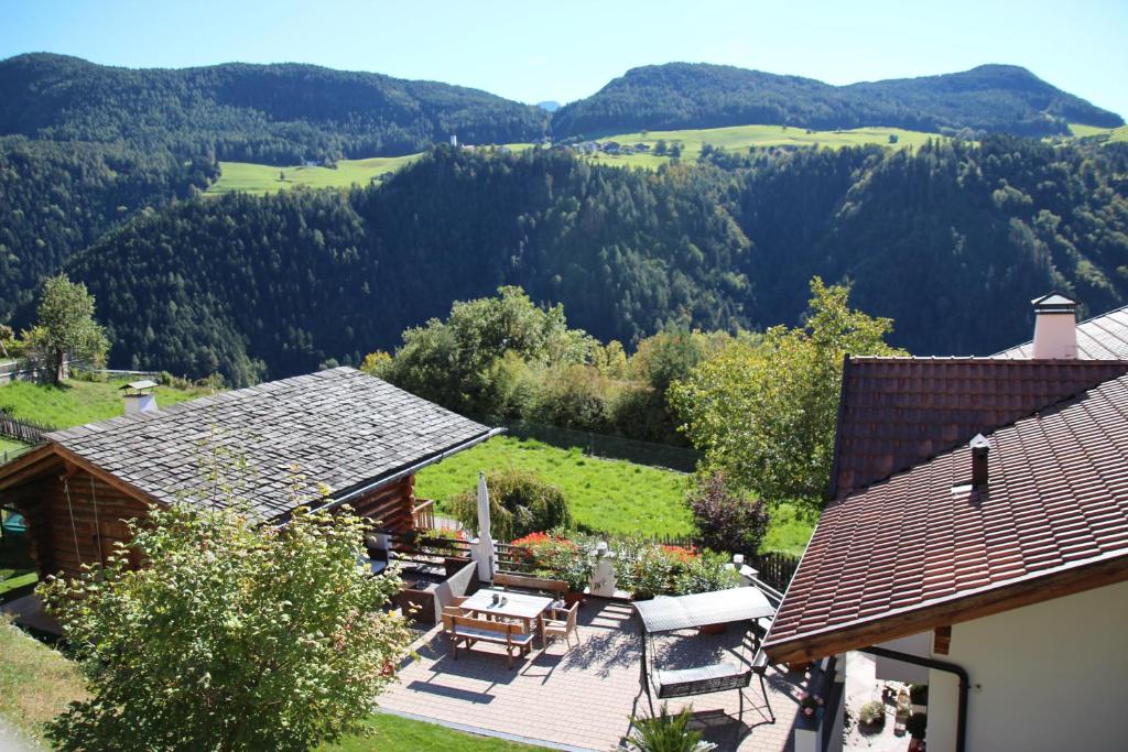 an aerial view of a house with a patio and mountains at Appartements Riegelehof in Laion