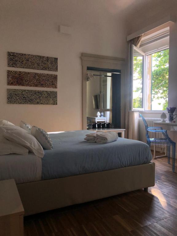 1 dormitorio con cama, mesa y espejo en B&B Dimor'à, en Pitigliano