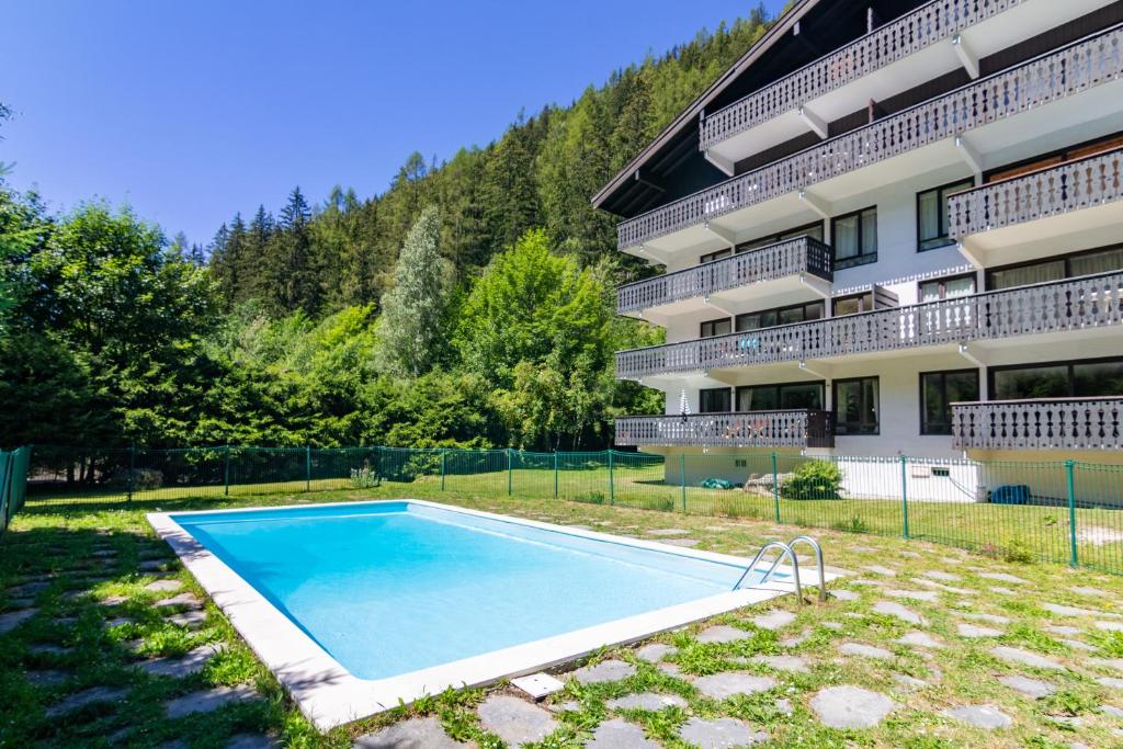 a swimming pool in front of a building at Résidence Androsace 42 Happy Rentals in Chamonix