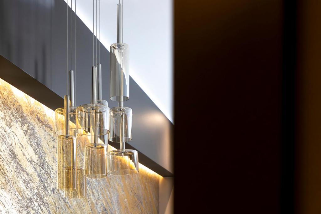a group of glass vases hanging from a wall at Milestone in Quartu SantʼElena