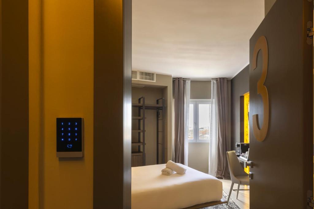 a hotel room with a bed and a desk at Milestone in Quartu SantʼElena