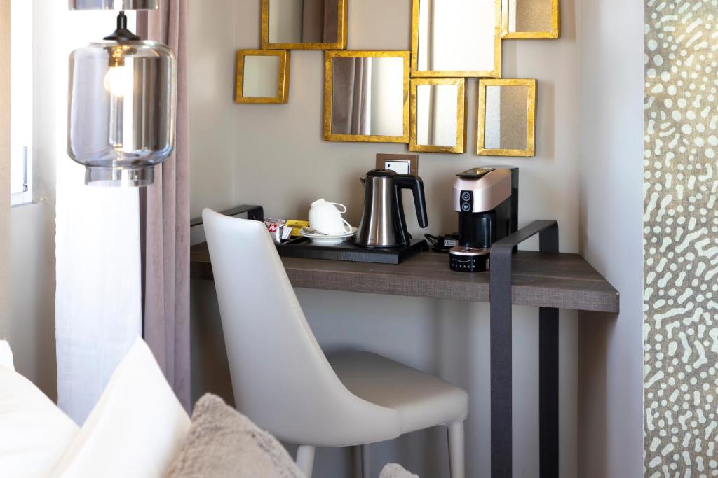 a room with a table with a chair and mirrors at Milestone in Quartu SantʼElena