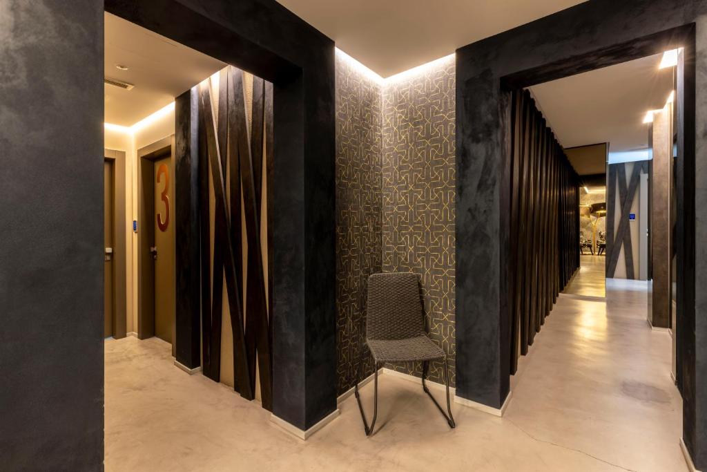a hallway with black walls and a chair at Milestone in Quartu SantʼElena