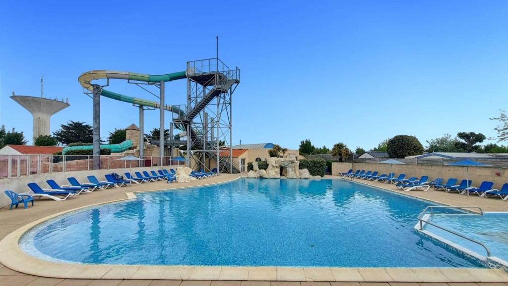une grande piscine avec des montagnes russes dans l'établissement Ti Punch - Sables-dOlonne Nord - Camping La Plage, à Saint-Hilaire-de-Riez