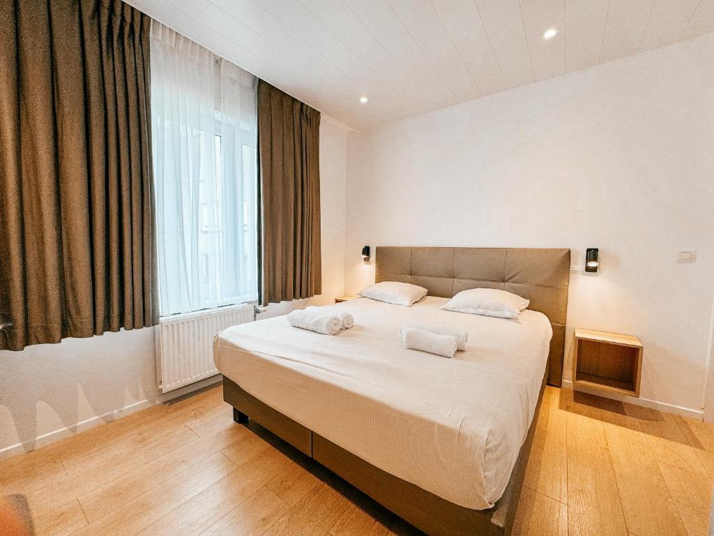 Postel nebo postele na pokoji v ubytování Alpha Hotel