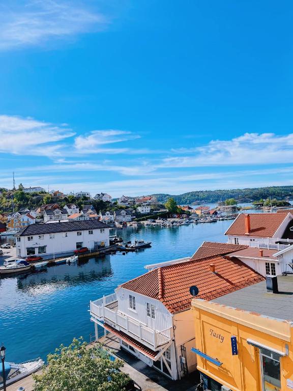 a view of a river with houses and a harbor at Kragerø Hotell in Kragerø