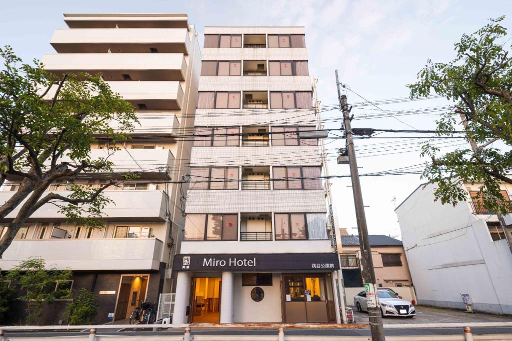 a white building with a minto hotel sign on it at Miro Hotel Momodanikoen-mae in Osaka