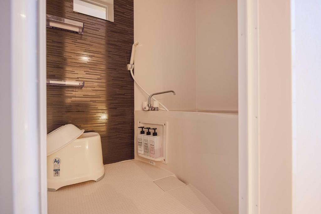 Postel nebo postele na pokoji v ubytování Miro Hotel Momodanikoen-mae