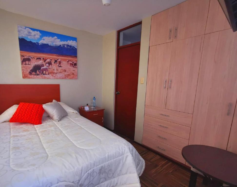 een slaapkamer met een bed en een grote houten kast bij Bon Repos Arequipa in Arequipa