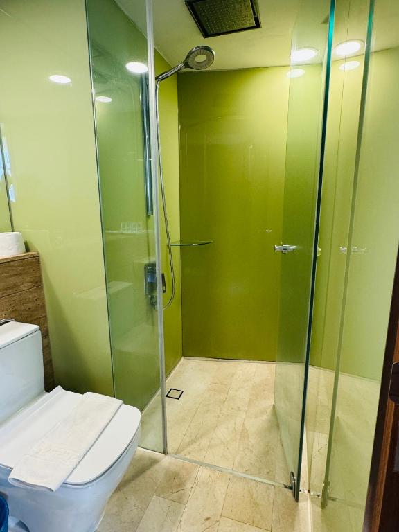 a bathroom with a toilet and a glass shower at Vortex Suites Klcc 2bedroom & 3bedroom apartment in Kuala Lumpur