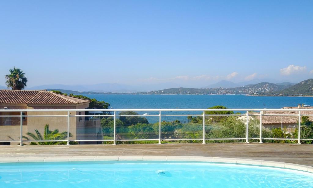 a swimming pool with a view of the water at Résidence Aigue Marine in Coti-Chiavari