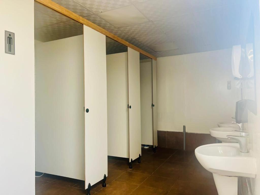 a bathroom with two sinks and two toilets at Dubai Tourism and Travel Services in Hunaywah