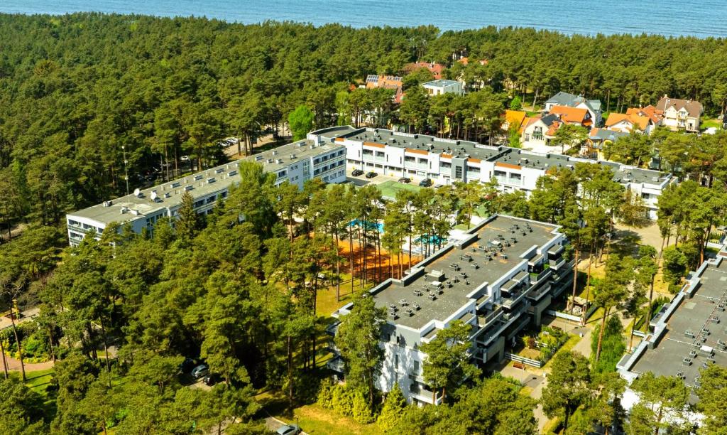 an aerial view of a building with trees at Baltic Inn in Pogorzelica
