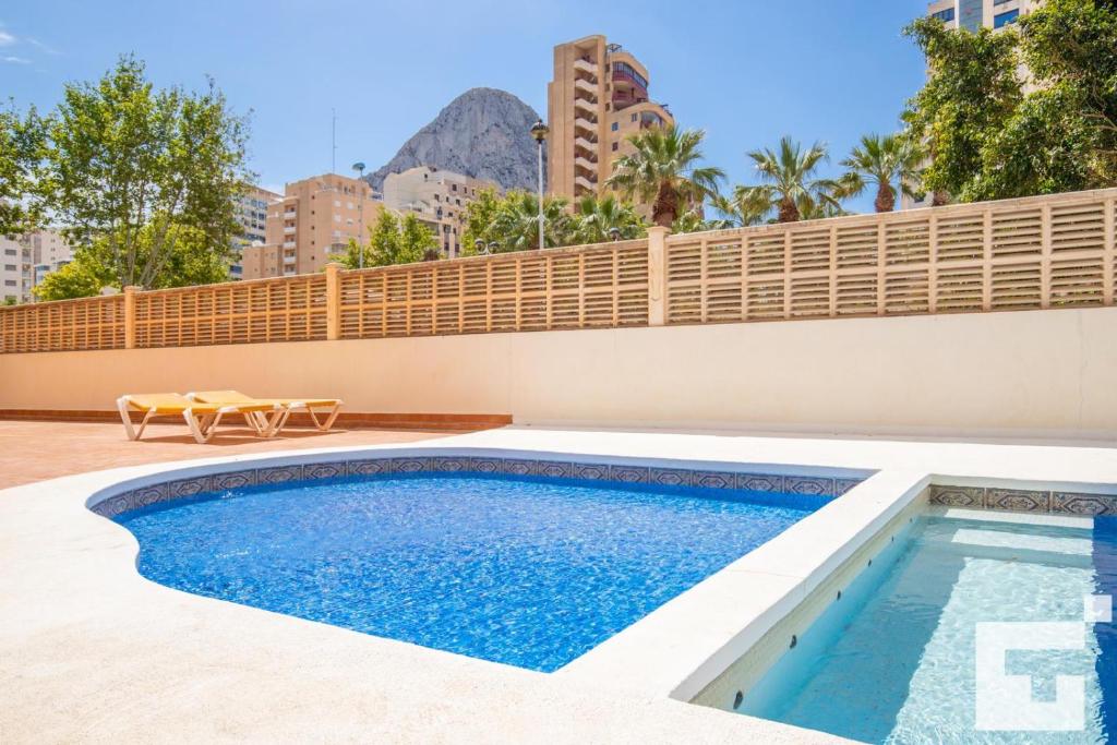 a swimming pool in the backyard of a house at Apartamento Racodifach 2B - Grupo Turis in Calpe