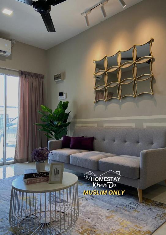 a living room with a couch and a table at Homestay Khan'Da Teluk Intan in Teluk Intan