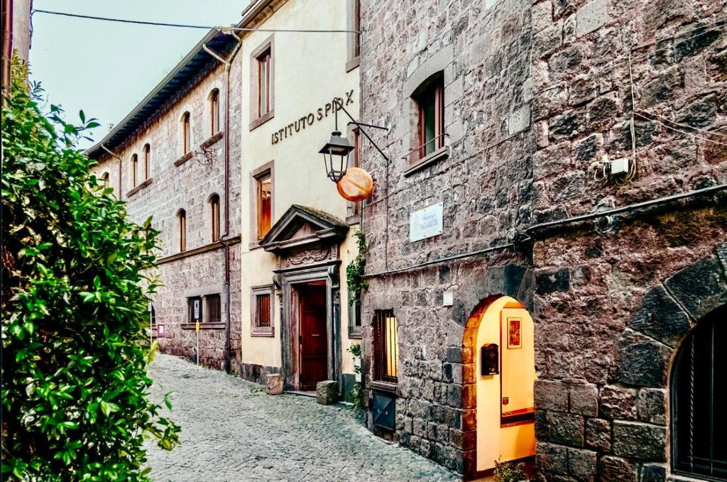 an alley in an old town with stone buildings at Nazareth Residence in Viterbo