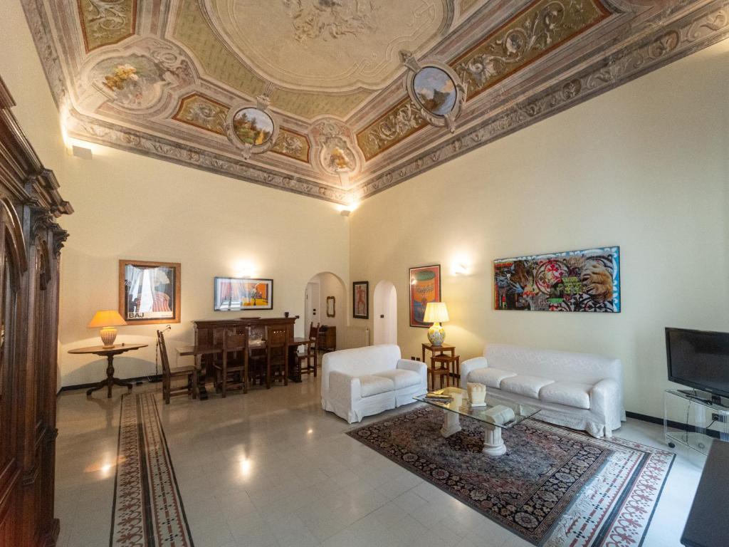 a living room with a coffered ceiling and white furniture at Casa Misette 200mq a due passi dal mare in Alassio