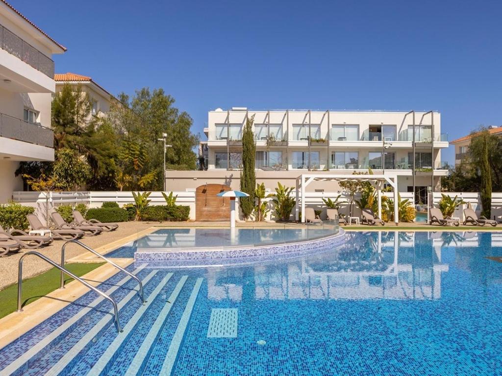 a large swimming pool in front of a building at Mythical Resort by KARMA in Paralimni