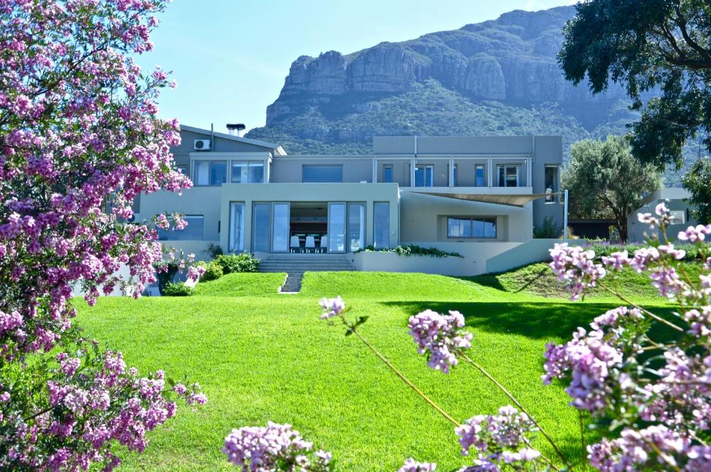 a view of a house with mountains in the background at Pure Guest House in Hout Bay