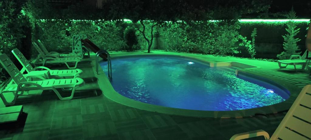 a swimming pool with two chairs and a table at Arslan Villa with Pool in Marmaris