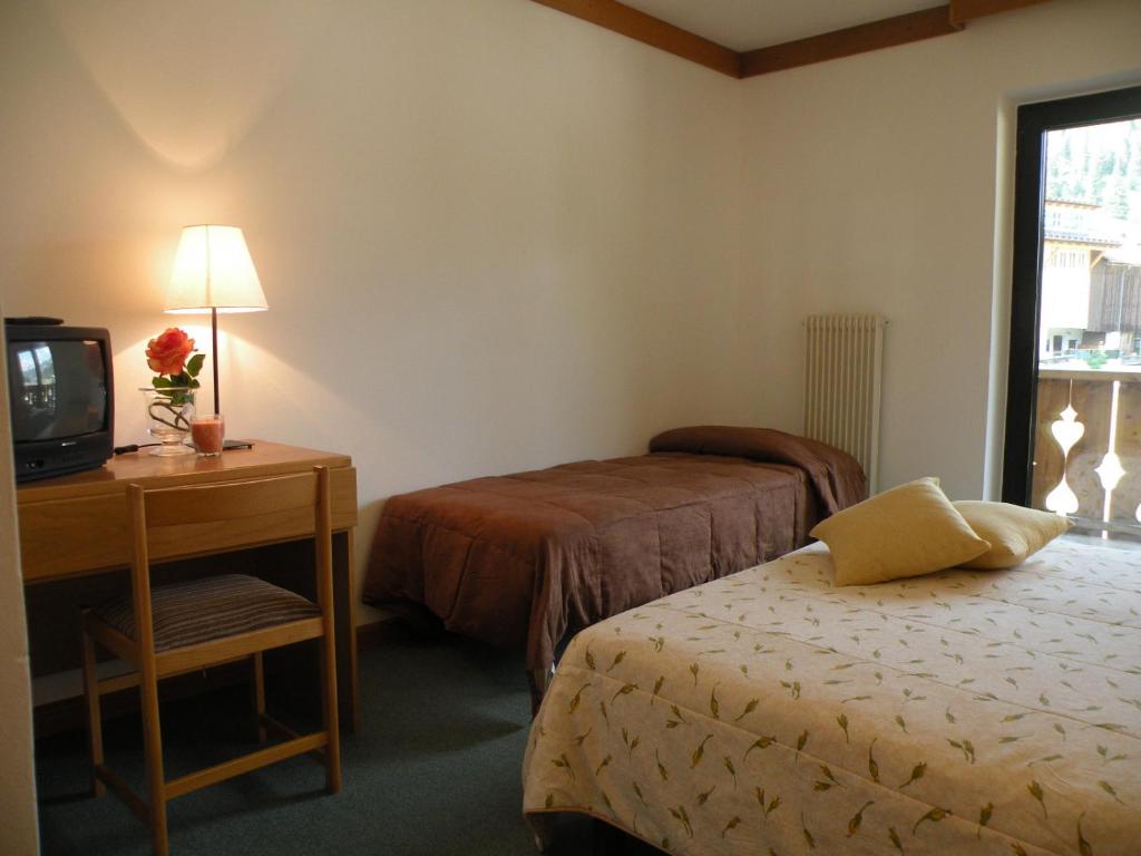 Postel nebo postele na pokoji v ubytování Hotel Vajolet