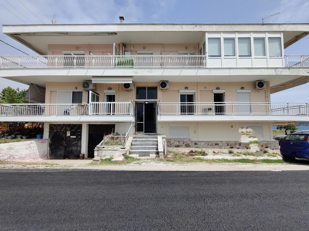an old building with a car parked in front of it at Eva Beach Studio in Néa Péramos