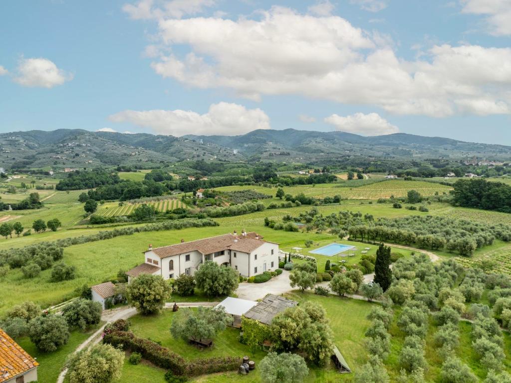 an aerial view of a house in a green field at Cantagrillo Boutique Resort in Vinci