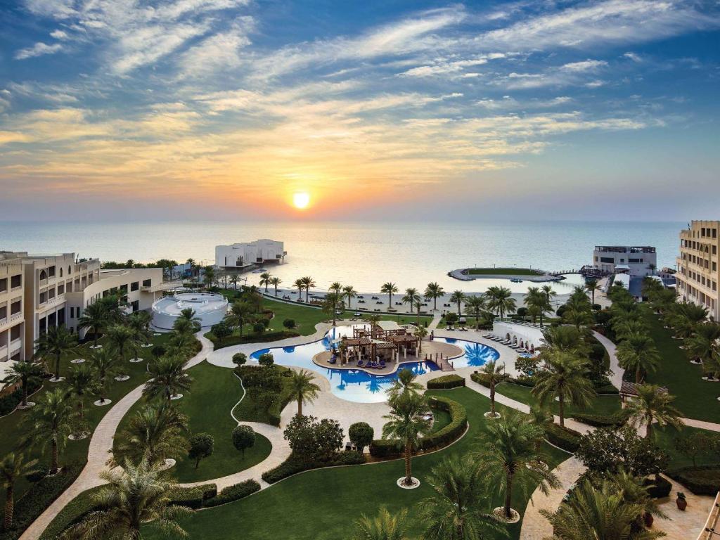 an aerial view of a resort with the ocean in the background at Sofitel Bahrain Zallaq Thalassa Sea & Spa in Manama