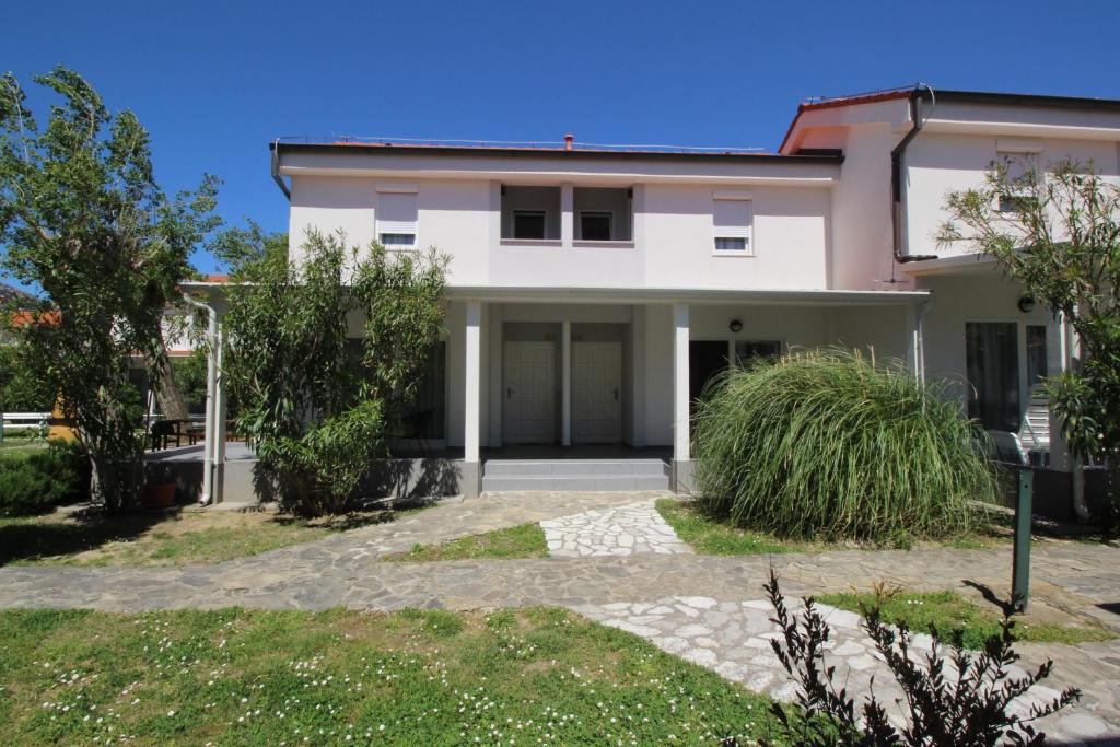 a large white house with a driveway at Villas Corinthia in Baška