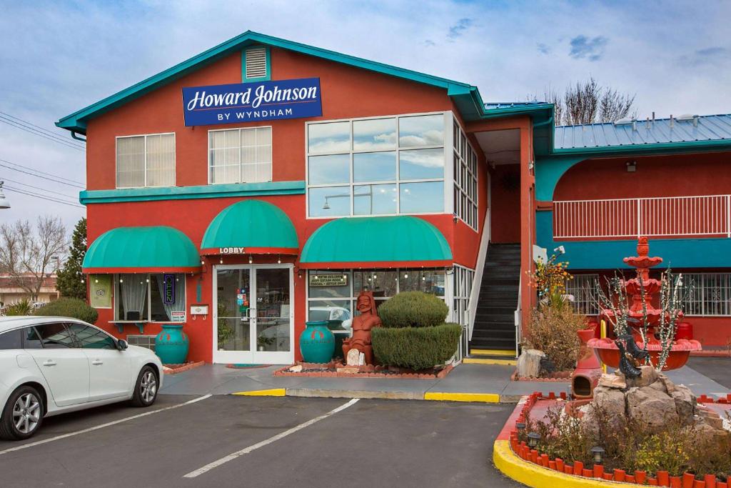 a store with a car parked in front of it at Sandia Peak Inn, a Howard Johnson by Wyndham in Albuquerque