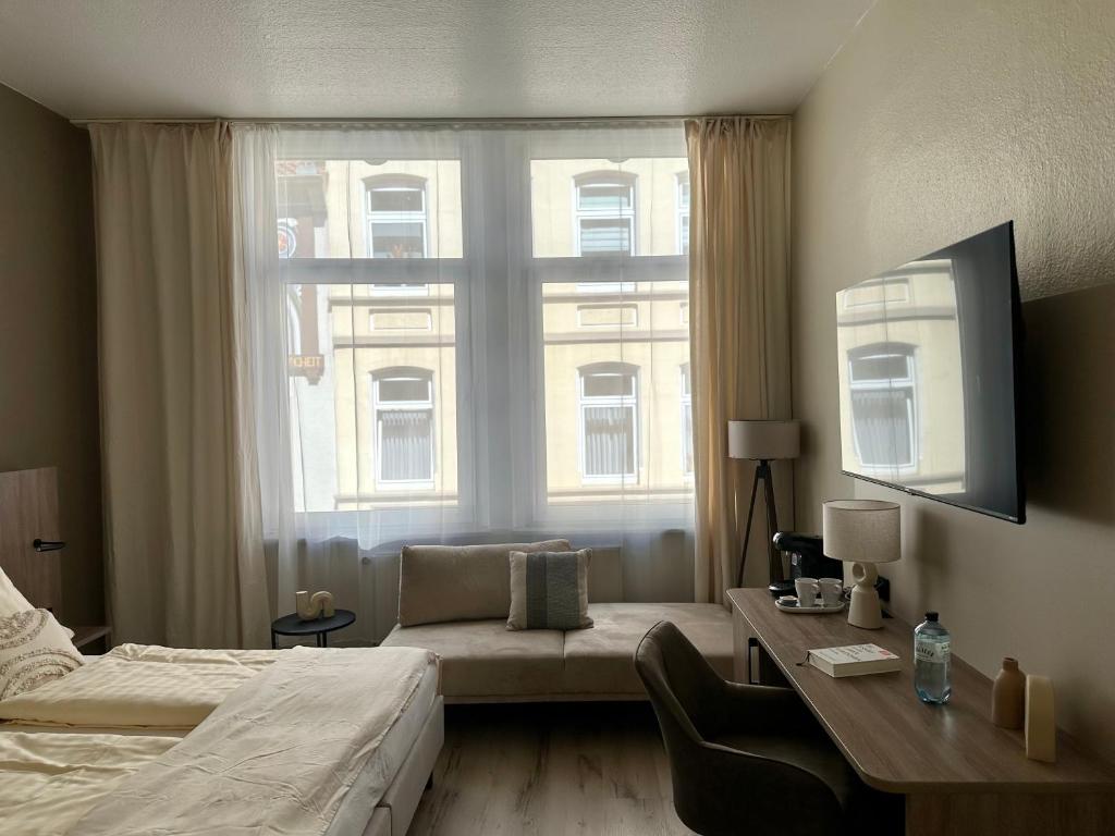 Ein Bett oder Betten in einem Zimmer der Unterkunft City Hotel Hameln