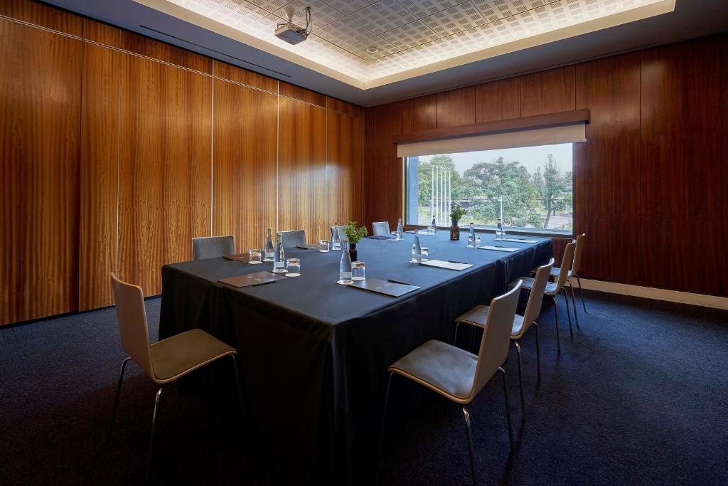 A private boardroom with a long table facing a broad window.