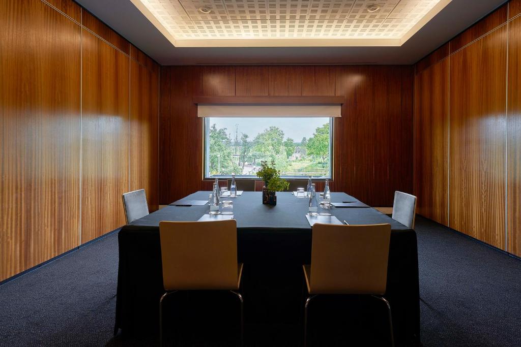 A small private meeting room with a window-facing table for four.